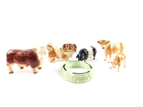 A Melba ware pottery figure of a bull, together with a Jersey cow, calf, Pekingese dog, and a pottery figure of a pig, and Falcon ware green pottery planter. (6)