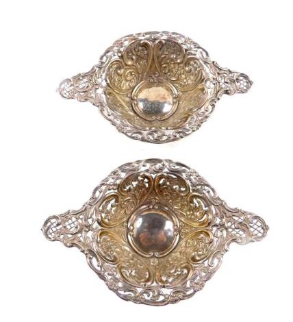 A pair of Victorian silver quaich sweetmeat dishes, with pierced and embossed floral and foliate scroll decoration, possibly Henry Matthews, Birmingham 1895, 5.02oz.