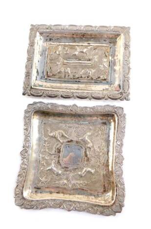 Two early 20thC Indian dishes, white metal, embossed with wild animals, within a c-scroll border, one dedication engraved to Miss V T Smith, 3.92oz.