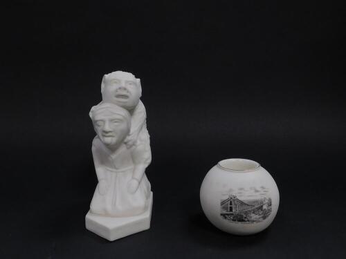 A late 19thC WH Goss parian figure group, modelled as the devil looking over Lincoln, 15cm H, together with a match striker, black printed with a view of Clifton Suspension Bridge, 7cm Dia. (2)