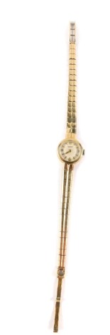 An International Watch Company 9ct gold cased lady's wristwatch, circular dial bearing Arabic numerals at quarters, case presentation engraved, on a 9ct gold strap, 15.7g all in.