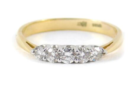 A diamond five stone ring, set in yellow metal stamped 18ct, approx 0.5ct, size T, 3.4g.