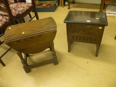 A small carved oak chest on pierced end supports and a small