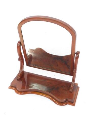 A Victorian mahogany swing frame toilet mirror, raised on a serpentine base, 76.5cm H, 67cm W, 28cm D.