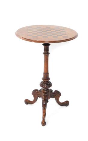 A Victorian walnut and chess board inlaid occasional table, the circular top raised on a turned and carved column, over three cabriole legs, leaf carved to the knees, 73cm H, 50cm Dia.