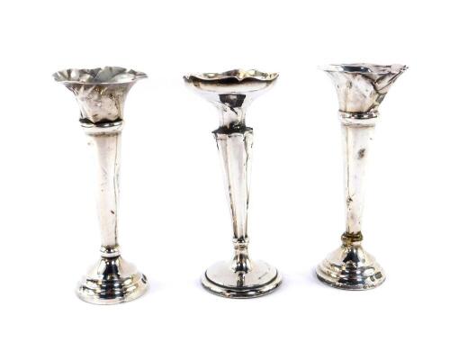A pair of George V silver loaded bud vases, Sheffield 1916, and a further loaded silver bud vase, Chester 1914, 5.96oz.