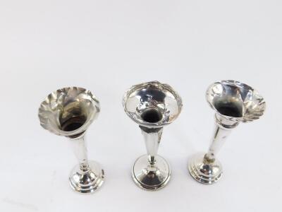 A pair of George V silver loaded bud vases, Sheffield 1916, and a further loaded silver bud vase, Chester 1914, 5.96oz. - 2
