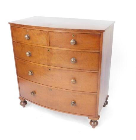 A Victorian mahogany bow front chest of drawers, with two short over three long drawers, raised on turned feet, 112cm H, 108cm W, 60cm D.