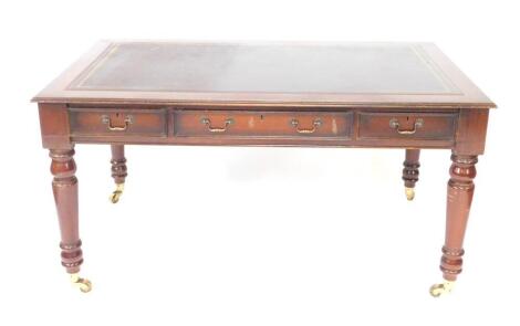 A Victorian mahogany desk, with a tooled brown leather top, over one long and two short drawers, raised on turned legs, brass capped on casters, 80cm H, 52cm W, 91.5cm D.