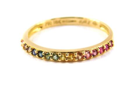 An 18ct gold and gem set half hoop eternity ring, the stones showing the colours of the rainbow, size N, 1.6g.