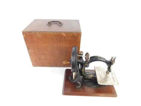 A late 19thC Willcox & Gibbs sewing machine, cased.