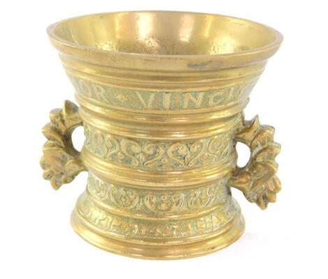 A Continental polished bronze pestle and mortar, "Amor Vincit Omnia 1771", Love Conquers All, 11cm H (2).