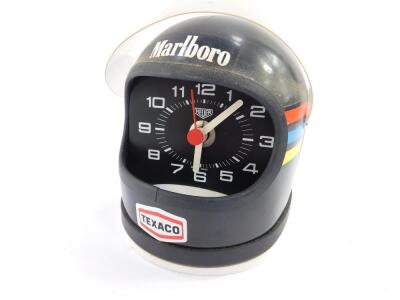 A Heuer desk clock modelled as James Hunt's helmet, black with decals, battery operated. - 2