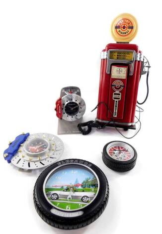 A Snap-On clock modelled as a disk brake, Snap-On wheel clock, two further automobilia clocks, and a phone modelled as a gasoline tank. (5)