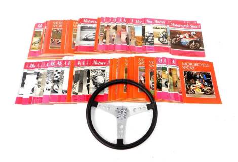 A chrome and leather bound steering wheel, together with 1970's and 80's Motorcycle Sports Magazines. (qty)