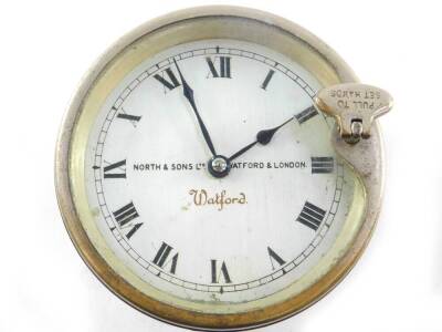 A Watford car clock by North & Sons Ltd of Watford, London, with silvered circular dial bearing Roman numerals, stamped to the reverse 2705.