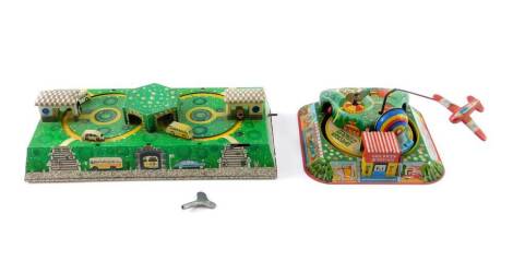 A 1950's USSR Abtotpacca tinplate clockwork bus station and road toy, with key, together with a Japanese tinplate clockwork children's train station, with key. (2)