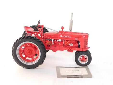 A Franklin Mint Precision Models die cast Farmall Model H tractor, 1:12 scale, red, with certificate of authenticity.