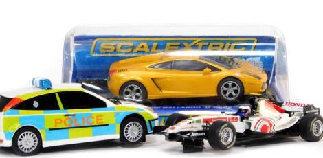 Three Scalextric model cars, comprising Lamborghini Gallardo, Honda Racing F1 car, and Ford Focus WRC police car.