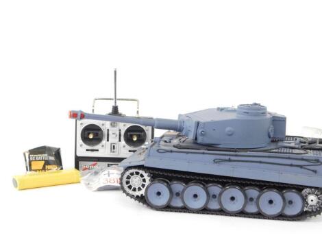 A radio controlled battle tank, modelled as a German Tiger 1 tank, 1:16 scale, with Sender radio control, and accessories.