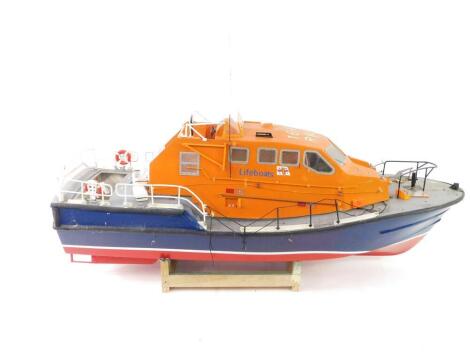 A kit built model Slipway RNLI Tamor Class Lifeboat, remote control model boat, 1:16 scale, orange, blue and red body, with assembly instructions and plans, 59cm H, 103cm L.