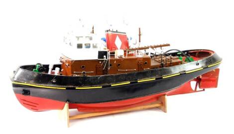 A Mountfleet Models kit built Logarth Motor Tug remote control boat, hull painted red and black, with assembly instructions, 36cm H, 96cm L.