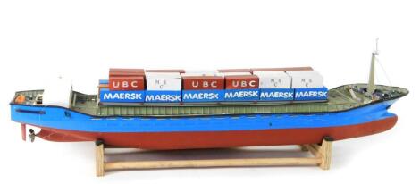 A kit built remote controlled model of a cargo ship Fairwind, blue and red body, with containers, 20cm H, 100cm L.