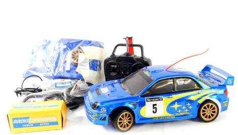 A Bycmo Subaru remote controlled car, with remote, parts, etc.