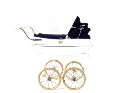 A mid 20thc Leeway doll's pram, white painted with blue fabric canopy, 83cm H, 90cm W.