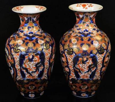 A pair of Meiji period Japanese Imari vases, each of baluster form, profusely decorated with panels, scrolls and flowers in orange and blue with gilt highlights, 30cm H. (2) - 4