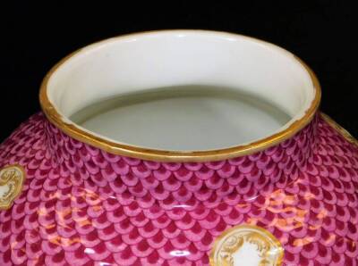 A pair of Meissen porcelain vases and covers, each exquisitely decorated with flowers, with domed circular lids surmounted by cherub and garland finials, each main body decorated with feathered pink and purple panelling, with further handpainted flowers o - 9