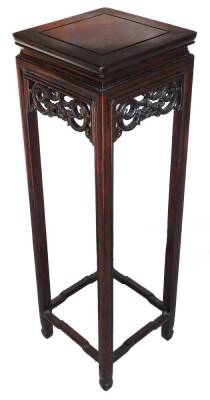 A Chinese hardwood plant stand, the square top raised above a pierced and carved scroll frieze, on square legs joined by shaped stretchers, 81cm H, 26cm W, 26cm D.