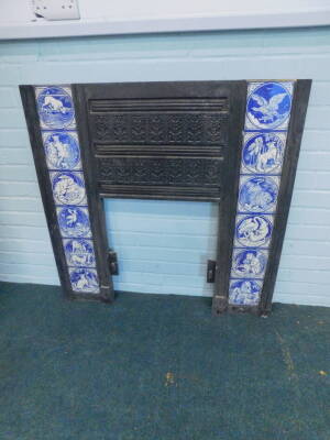 A pair of Victorian cast iron fire surrounds, each set with twelve Minton tiles, printed in blue with a design of Aesops Fables, after Moyr-Smith, 97cm H, 97.5cm W. Provenance: Removed from Leyland House, Nettleham Road, Lincoln. The house was designed by - 13