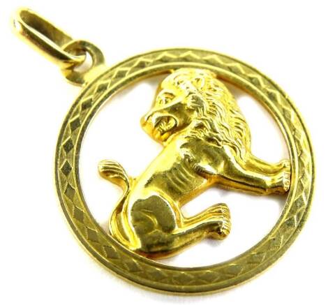 An 18ct gold lion pendant, the circular pendant with seated lion to centre, marked 750, 3.9g all in.