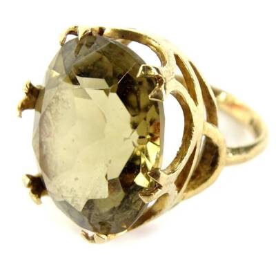 A 9ct gold dress ring, with oval cut citrine, in six double claw setting, in a raised basket, ring size K, 6.7g all in.