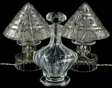 Various cut glassware, comprising a pair of lamps with mushroom stoppers on circular feet, 26cm H, and a decanter with compressed stopper. (3)