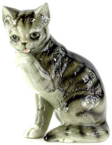 A Goebel Hummel figure, of a standing cat licking its front paw, printed marks beneath, 26cm H.