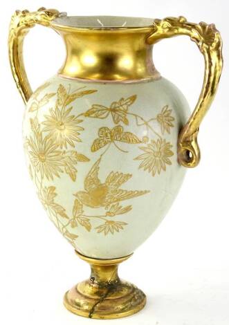 An Edwardian pottery vase, of large proportion, with elaborate handles, the tapering circular body decorated with flowers and bird, 38cm H (AF).