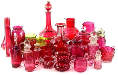 Various cranberry and red glassware, to include early 20thC and later examples, jug with tapering body and plain glass handle, 14cm H, decanter with gilt highlights, hand bell, etc. (a quantity)