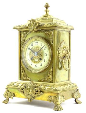 A 20thC rococo style gilt metal mantel clock, the elaborate stepped case with floral finial raised above lions or side lions mask ring handles and hairy paw feet with floral scrolls to the knee, holding a 12cm dia Arabic dial with fancy pierced centre, re