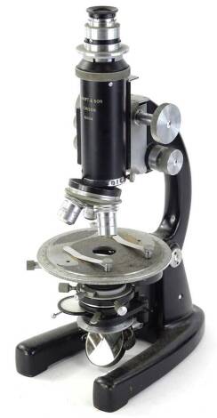 A 20thC J Swift and Son London microscope, number 32004, with shaped stage, articulated lens and c shaped stand, with horses shoe base, 39cm H.