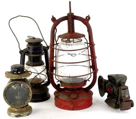 Various early 20thC carriage lanterns, etc., one in red with clear glass centre, 41cm H, in a mesh work cage, marked and numbered, and two carriage lights, one with red and green glass lenses to the side. (a quantity)