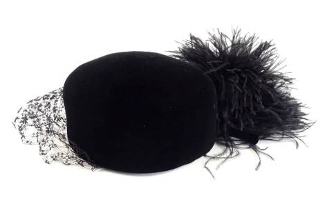 A vintage Christian Dior black hat, with front veil and feathered type tassel, with Diorling label, in outer box.
