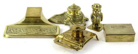 Various early 20thC brass inkwells, to include one of shaped form with circular well, 12cm W, another of a figure in regency dress, etc. (a quantity)