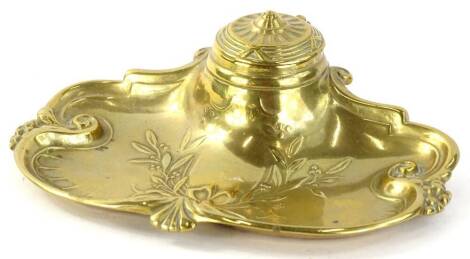 An early 20thC brass inkstand, of shaped form with central well with circular lid, raised with garlands and shields, 16cm W.