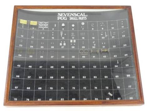 A display board for Sevenscal Pug small parts, made for the model railway collectors, probably O gauge in glazed frame.