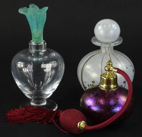 A Daum scent bottle and stopper with printed label and etched mark, (AF) a Mdina white and silver trailed iridescent glass scent bottle and stopper, 13cm H, an Isle of White iridescent glass scent bottle in original packaging (3)