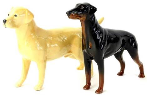 Two Beswick dogs, a Labrador Champion Wendover and a Doberman.