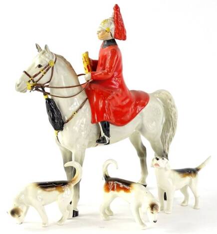 A Beswick figure of a lifeguard soldier, seated on a light dappled grey horse and three Beswick beagles (AF).