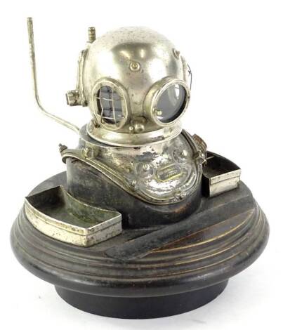 An unusual Siebe Gorman & Co of London inkwell, modelled in the form of a divers helmet, on an ebonised base (AF)